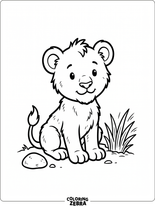 A baby lion sits near a little patch of grass