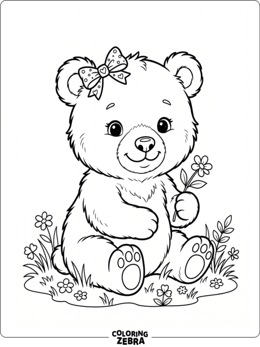 A cute baby bear sitting beside a flower