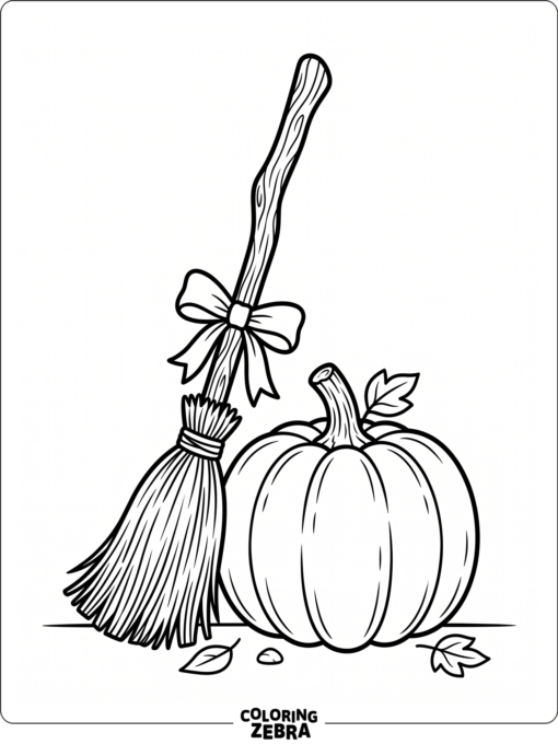 A witch broomstick resting near a pumpkin