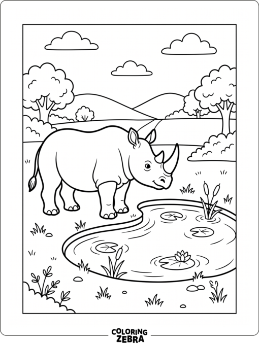A rhinoceros stands beside a small pond