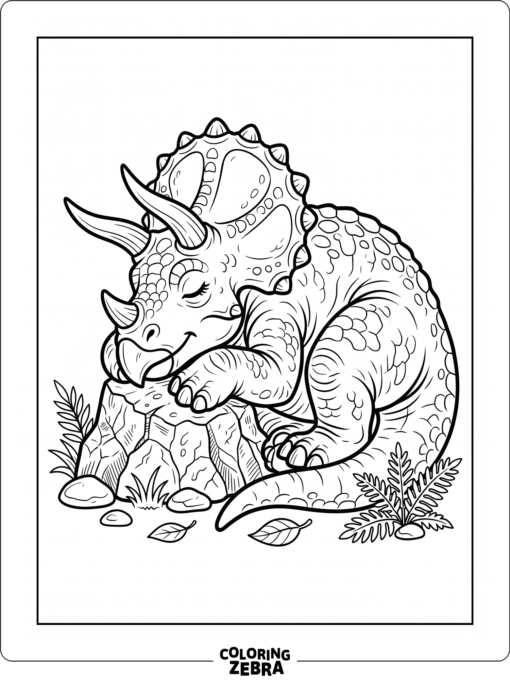A sleeping triceratops resting beside a rock